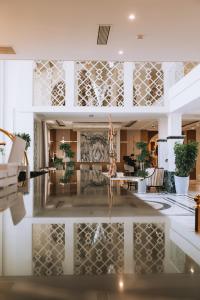 a lobby with a reflection of a living room at Medina Palace Hotel in Türkistan +135 photos