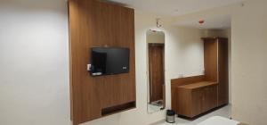 a room with a flat screen tv on a wall at Hotel Glory in Bavla +15 photos