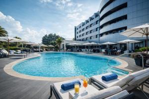 a swimming pool with lounge chairs and a hotel at Amatì Design Hotel in Zola Predosa