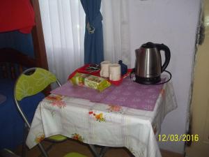 a table with a tea kettle on top of it at Max in El Chalten