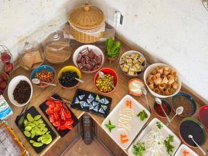 a table with various bowls of food on it at Erdu Cappadocia Stone House in Avanos