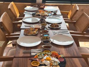 a long table with plates of food on it at Erdu Cappadocia Stone House in Avanos