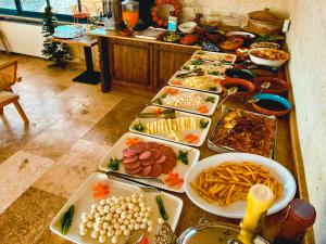 a buffet with many plates of food on a table at Erdu Cappadocia Stone House in Avanos
