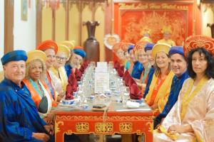 a group of people sitting at a long table at Thanh Lich Hue Hotel in Hue