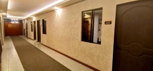 a hallway in a building with a door and a hallway sidx sidx at Dancenter Airport Hotel - Grey Hotel in Pampang