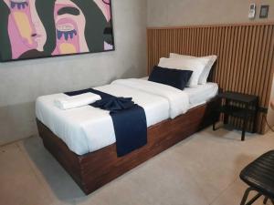 a bedroom with a bed with white and blue sheets at Dancenter Airport Hotel - Grey Hotel in Pampang