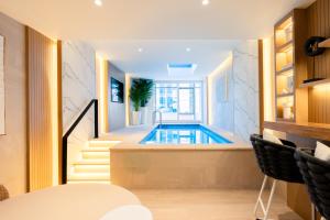 a swimming pool in a house with a staircase at Al Bandar Rotana – Dubai Creek in Dubai