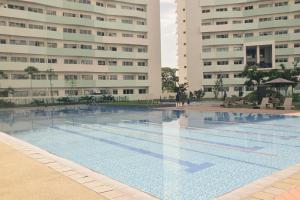 a swimming pool in front of two tall buildings at Relaxing Mountain View 2BR Fast WiFi and PS5 in Manila