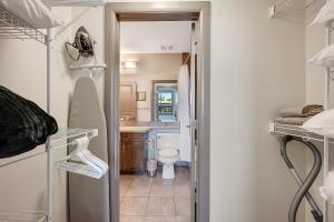 a small bathroom with a toilet and a sink at Upper Floor w Courtyard View 550 in Kelowna +15 photos