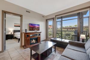 a living room with a fireplace and a couch at Upper Floor w Courtyard View 550 in Kelowna