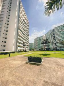 a large building in a city with tall buildings at Relaxing Mountain View 2BR Fast WiFi and PS5 in Manila