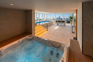 a jacuzzi tub in a room with a view at Al Bandar Rotana – Dubai Creek in Dubai