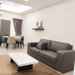 a living room with a couch and a table at Happpy Impiana Guest House in Bentong