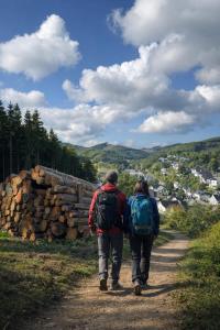 a couple of people walking down a dirt road at Landhotel Laarmann in Lennestadt