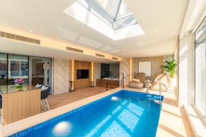 a house with a swimming pool and a living room at Al Bandar Rotana – Dubai Creek in Dubai