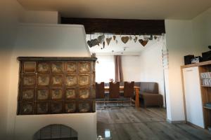 a living room with a fireplace and a dining room at Wasser & Bergwelt Appartement Kärnten in Seeboden