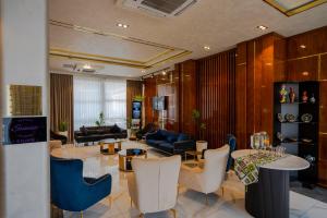 a living room with a table and chairs at UNIQUE Airport Hotel in Tashkent
