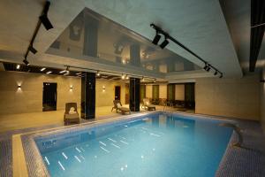 a large swimming pool in a hotel room at UNIQUE Airport Hotel in Tashkent