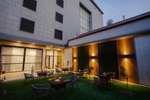 a courtyard with tables and chairs in a building at UNIQUE Airport Hotel in Tashkent