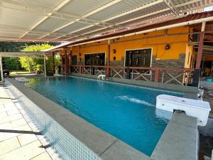 a large swimming pool in front of a building at 6Tamarind in Gholvad +22 photos