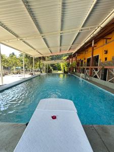 a large swimming pool with a pool at 6Tamarind in Gholvad