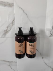 two bottles of hair products sitting on a counter at White Rocks Meteora in Kalabaka