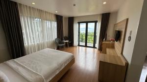 a bedroom with a bed and a room with a window at Rosso Sky Villa Phu Quoc in Phú Quốc +54 photos