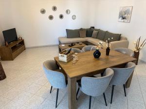 a living room with a table and a couch at Afandou Panorama Apartment in Afantou
