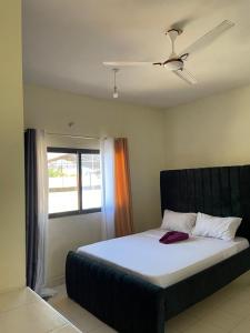 a large bed in a room with a window at Murangiri Accommodations Mahnoor in Mombasa
