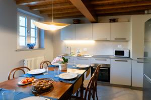 a kitchen with a wooden table and a dining room at Lo scrigno di Camilla in Capannori