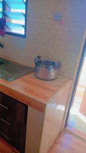 a pot sitting on top of a counter in a kitchen at Murangiri Accommodations Mahnoor in Mombasa +30 photos