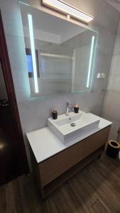 a bathroom with a white sink and a mirror at Potokaki Coastal Haven in Potokáki +52 photos