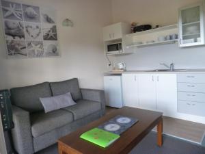 a living room with a couch and a table at Opua Boutique Seaview Motel in Opua