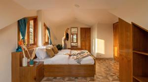 a bedroom with a bed with a woman jumping on it at Kalra Regency Shimla in Shimla +50 photos