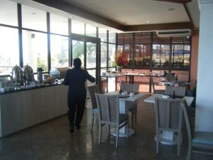 a person walking into a restaurant with a counter at Fortaleza 703--Fortaleza 713 in Fortaleza