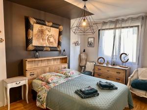 a bedroom with a bed and a dresser and a mirror at Villa du Siéck bord de mer piscine 14 P in Santec +79 photos
