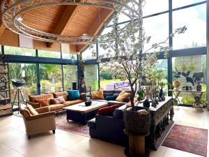 a large living room with couches and a table at Villa du Siéck bord de mer piscine 14 P in Santec