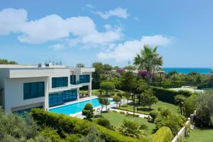 a villa with a swimming pool and a garden at Susesi Luxury Resort in Belek