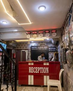 a man sitting at a counter in a restaurant at Hotel Cloud Inn in New Delhi