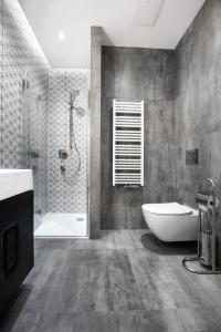 a bathroom with a shower and a tub and a sink at Kalia Apartments in Warsaw