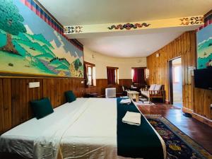 a bedroom with a large bed and a living room at sinchula Villa Resort in Paro