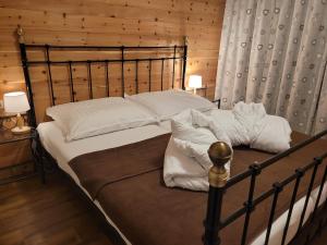 a large bed in a room with wooden walls at Ferienwohnung Schmiedhofer in Ellmau