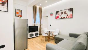 a living room with a couch and a tv at Vila KAM in Vlorë