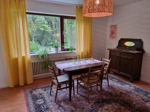 a dining room with a table and chairs and a window at Gemütliche Ferienwohnung mit Blick ins Grüne in Wadern