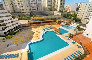 an aerial view of a large swimming pool in a city at Rocha Paradise Apartment in Portimão +25 photos