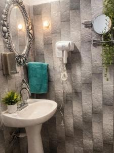 a bathroom with a sink and a mirror at Suites Acapulco Real in Acapulco +6 photos