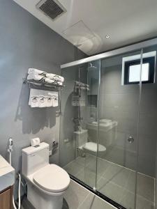 a bathroom with a toilet and a glass shower at Achi Ocean Villa in Cửa Lô +37 photos