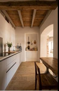 a kitchen with a wooden table and a wooden floor at Corte del Cedro in Provaglio d'Iseo