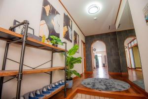 a hallway of a home with wooden floors and shelves at TIDA house urasoe in Urazoe +59 photos