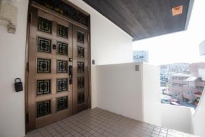 a door in a room with a view of a city at TIDA house urasoe in Urazoe